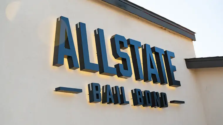 Allstate Bail Bond illuminated sign at dusk